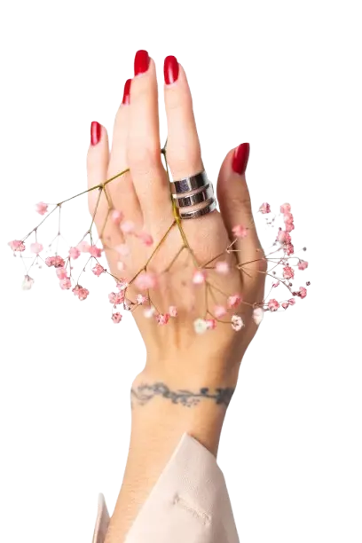 Shop online for a wide range of trendy nail designs, nail colors, nail polishes and nail care products. Women's hands with red nail polish and rings on their fingers are adorned with a pink flower garland. The text below reads "All kinds of trending nail designs are available along with nail colors and nail polishes.